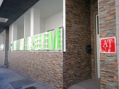 a brick wall with a sign on the side of a building at Apartamentos Antares 2 in Milladoiro