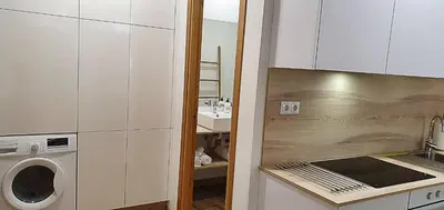a kitchen with a washer and dryer on a counter at Apartamentos Antares 2 in Milladoiro