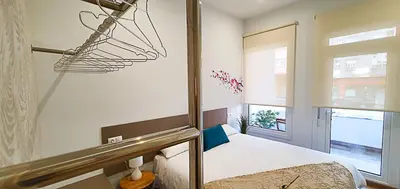 a bedroom with a bed and a window at Apartamentos Antares 2 in Milladoiro