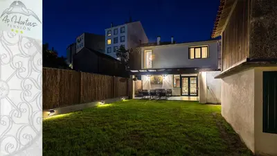 a house with a yard at night with lights at Pensión As Hortas in Palas de Rei
