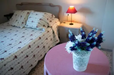 a bedroom with a table with a vase of flowers on it at Casona de Rabanal-Oca in Rabanal del Camino