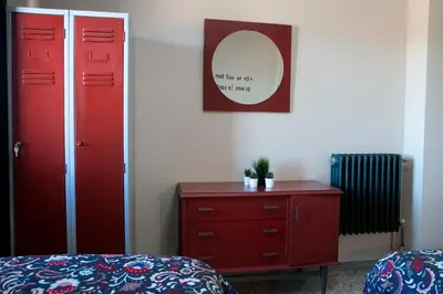 a bedroom with a red dresser and a red cabinet at Casona de Rabanal-Oca in Rabanal del Camino
