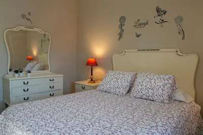 a bedroom with a bed with a dresser and a mirror at Casona de Rabanal-Oca in Rabanal del Camino