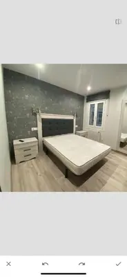 a large bedroom with a bed and a wall at Residencia Compostela in Santiago de Compostela