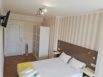 a bedroom with a white bed with two towels on it at Residencia Compostela in Santiago de Compostela