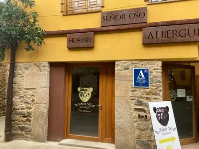 a store with a sign in front of a door at SEÑOR OSO in Molinaseca
