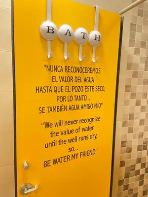 a sign in a bathroom with a warning about water at SEÑOR OSO in Molinaseca