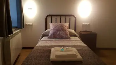 a small bedroom with a bed with a tray on it at La Posada del Druida in Foncebadón