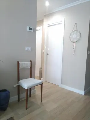 a white room with a chair and a door at Torre Center II in Santiago de Compostela