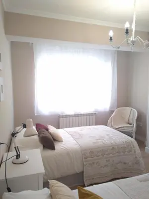a bedroom with two beds and a window at Torre Center II in Santiago de Compostela