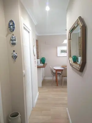 a hallway with a mirror and a table at Torre Center II in Santiago de Compostela