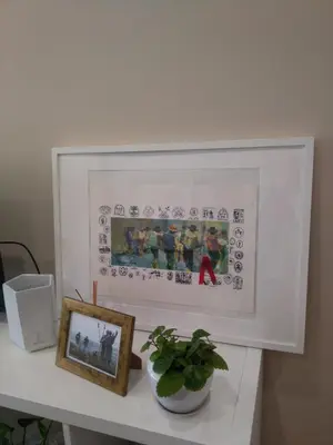 a picture frame on a white table with a plant at Torre Center II in Santiago de Compostela