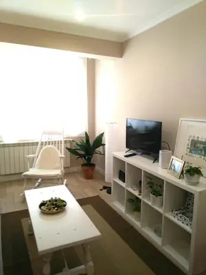 a living room with a television and a table at Torre Center II in Santiago de Compostela
