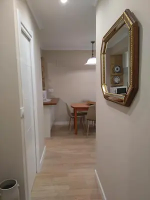 a hallway with a mirror and a dining room at Torre Center II in Santiago de Compostela