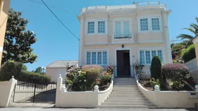 a white house with a staircase in front of it at Casa Braña in Barreiros
