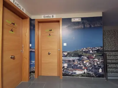 a hallway with two doors with a painting on the wall at Duerming Family Viveiro 3 Rooms in Viveiro