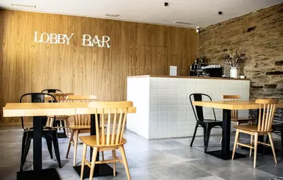 a restaurant with wooden tables and chairs and a bar at A Casa da Botica in Samos