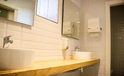 a bathroom with two sinks and a mirror at A Casa da Botica in Samos