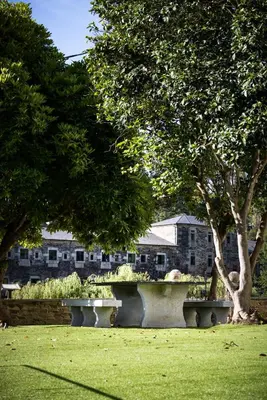 a bench in the middle of a park with trees at A Casa da Botica in Samos