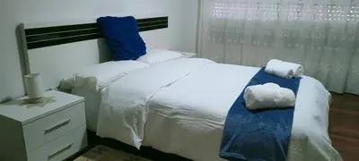 a bedroom with a bed with two towels on it at Apartamento de 4 habitaciones en el Centro de Monforte in Monforte de Lemos