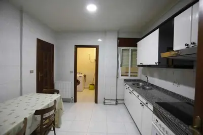 a kitchen with a table and a sink in it at Apartamento de 4 habitaciones en el Centro de Monforte in Monforte de Lemos