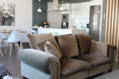 a living room with a couch and a kitchen at FOROPLAZA Porta San Pedro Pleno Centro Vistas Muralla in Lugo