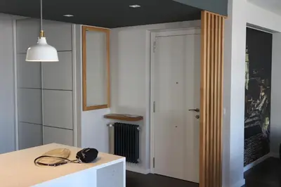 a room with a table and a hallway with a door at FOROPLAZA Porta San Pedro Pleno Centro Vistas Muralla in Lugo