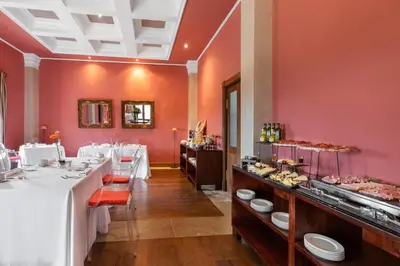 a restaurant with a long row of tables with food at Áurea Palacio de Sober by Eurostars Hotel Company in Sober
