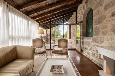 a living room with a couch and two chairs at Áurea Palacio de Sober by Eurostars Hotel Company in Sober
