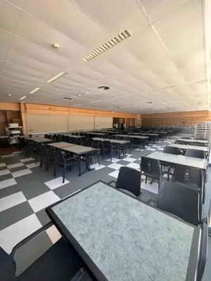 a large room with tables and chairs in it at Albergue Monte Do Gozo in Santiago de Compostela