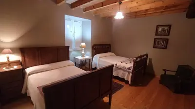 a bedroom with two beds and a window at Casa Valle in Foz