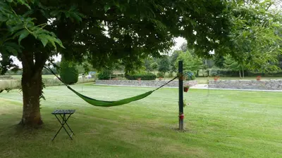 a hammock hanging from a tree in a park at Casa Valle in Foz