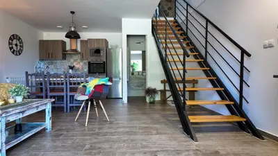 a staircase in a living room next to a kitchen at PANTON RURAL Casa Do José in Pantón