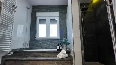 a bathroom with a bath tub and a window at PANTON RURAL Casa Do José in Pantón