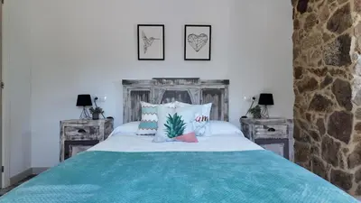 a bedroom with a bed and two night stands at PANTON RURAL Casa Do José in Pantón