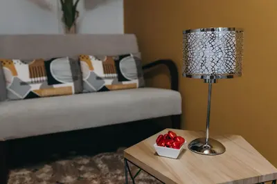 a lamp on a table next to a bed at PR Campanas de San Juan in Santiago de Compostela