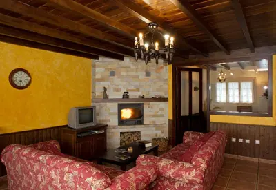 a living room with a couch and a fireplace at Apartamentos Porcia in Tapia de Casariego