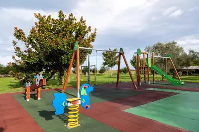 a park with a playground with a slide and swings at Apartamentos Porcia in Tapia de Casariego