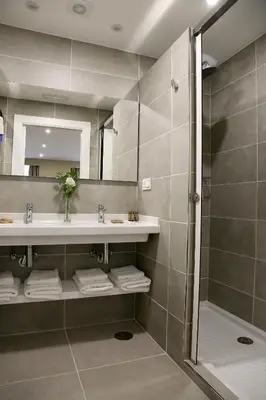 a bathroom with a sink and a shower at VÍA XIX in Caldas de Reis