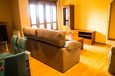 a living room with a couch and a table at EDIFICIO CINE MON in Burela de Cabo