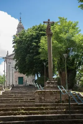 a group of stairs leading to a building with a pillar at Pensión Dorotea in Lavacolla