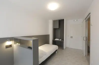 a small bedroom with a bed and a desk at Pensión Dorotea in Lavacolla