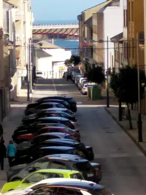a row of cars parked in a parking lot at Ribadeo Centro in Ribadeo