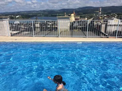a woman swimming in a large swimming pool at Ribadeo Centro in Ribadeo