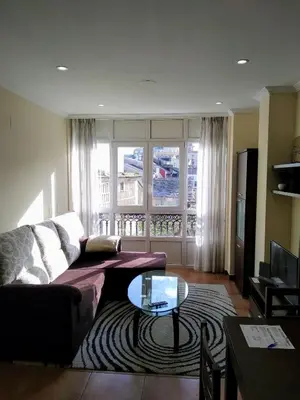 a living room with a couch and a glass table at Ribadeo Centro in Ribadeo