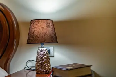 a lamp sitting on a table next to a bed at Apartamento Lemavos in Monforte de Lemos