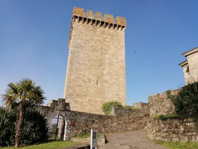 a tall brick tower next to a wall at Apartamento Lemavos in Monforte de Lemos