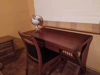 a wooden desk with a globe on top of it at nice apartment Don Santiago in Santiago de Compostela