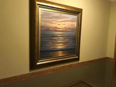 a painting of the ocean on a wall at nice apartment Don Santiago in Santiago de Compostela