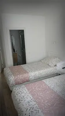 two beds sitting next to each other in a room at La mesa del cocinero in Lugo